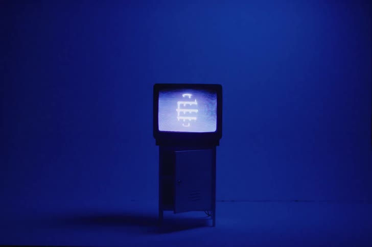 A television sitting on a cabinet is displayed in a room