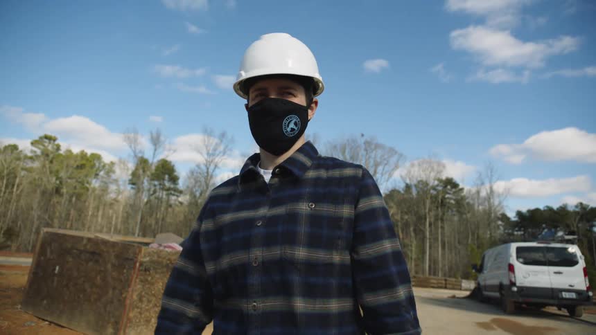 A construction worker walks outside a construction site