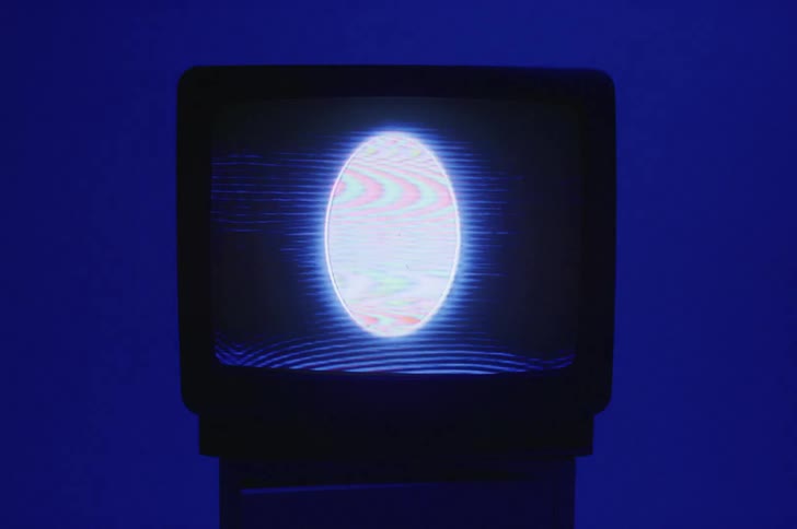 There is a television screen inside a room