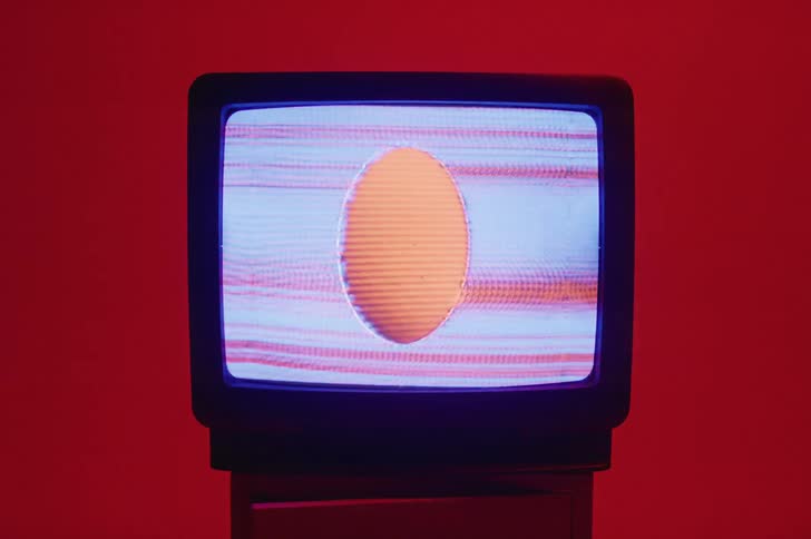 An egg shaped sphere and static play on a television