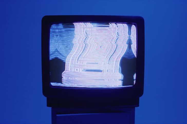 There is a television with blue colors on the screen