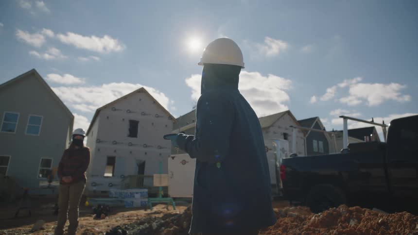 Two people are working together in the construction field