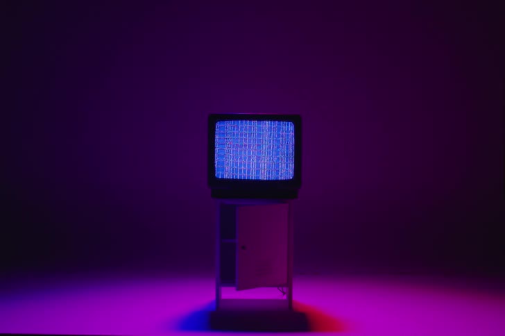 A television is displayed on a cabinet indoors