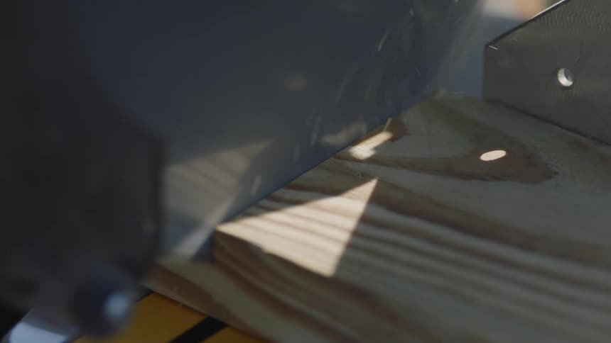Close up of a saw sawing through wood
