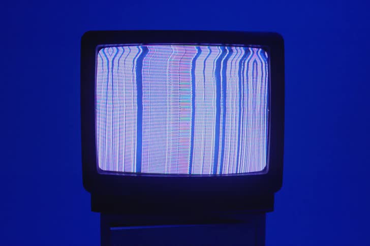 A television is an a room with blue walls and an oval changes to warped lines that are slowly moving across the screen