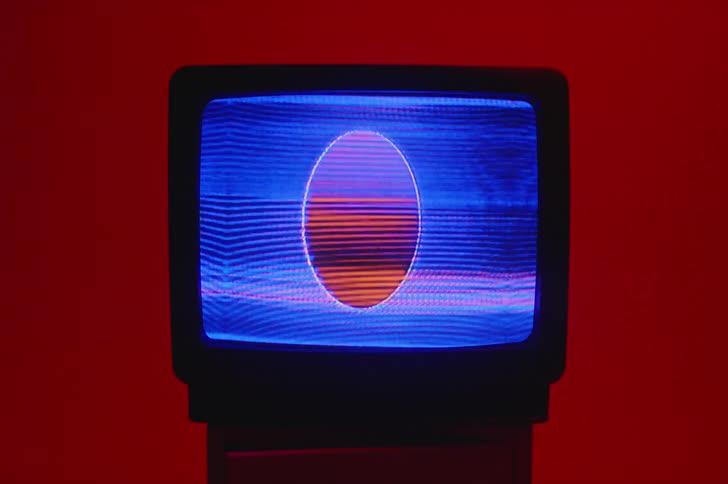 A circle and static play on a box style television