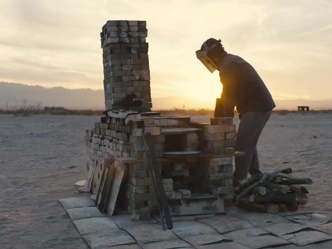 A man is working with an outdoor forge
