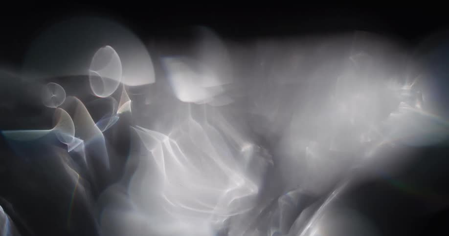 Light reflects and shimmers off ribbons of smoke and smoke rings
