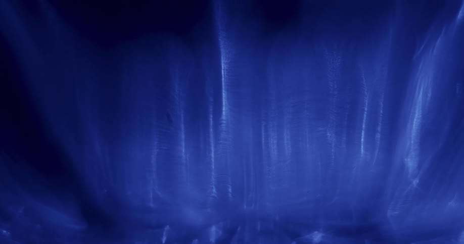Waves of blue electric light moving against a black background