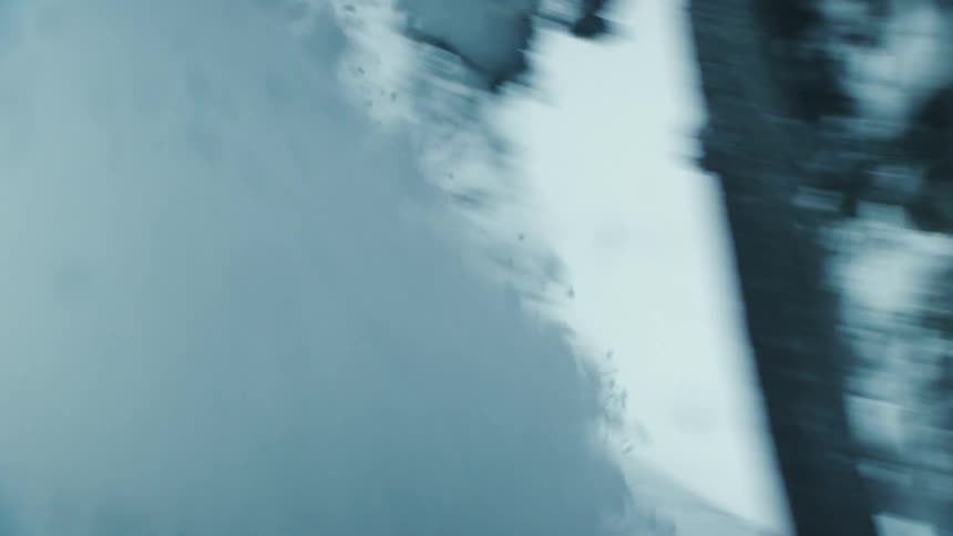 There is a person that is snowboarding outside in the day time