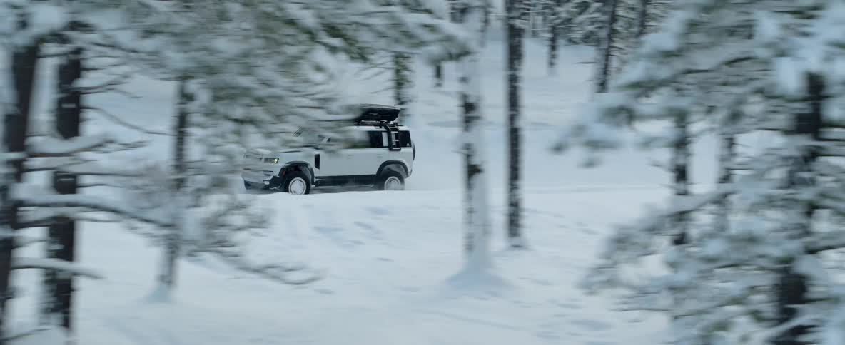 A sport utility vehicle with drives along a forest road during the thick of winter
