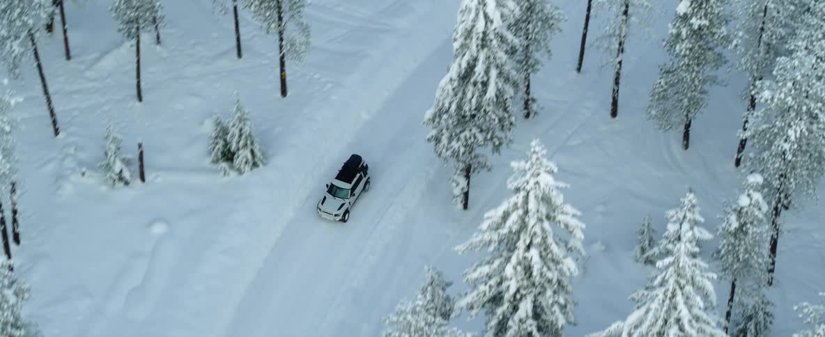 There is someone that is driving outside in the winter time