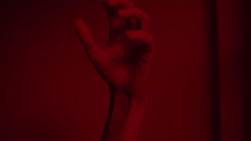 A person is clenching their fist angrily