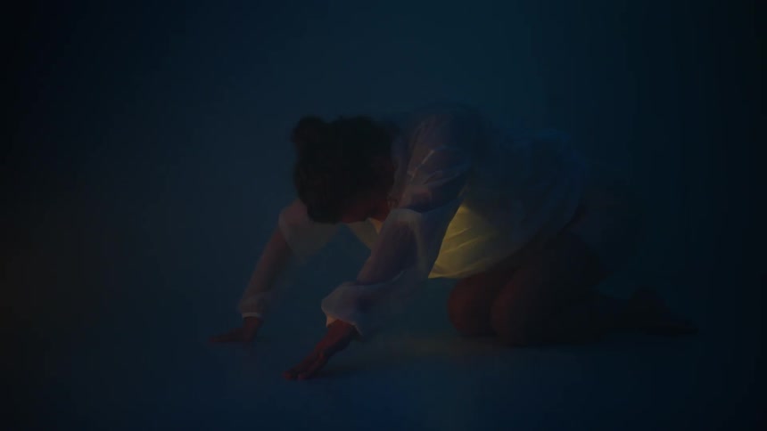 A woman is stretching and doing yoga during the night time
