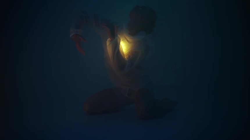 A woman is dancing with an orb outdoors