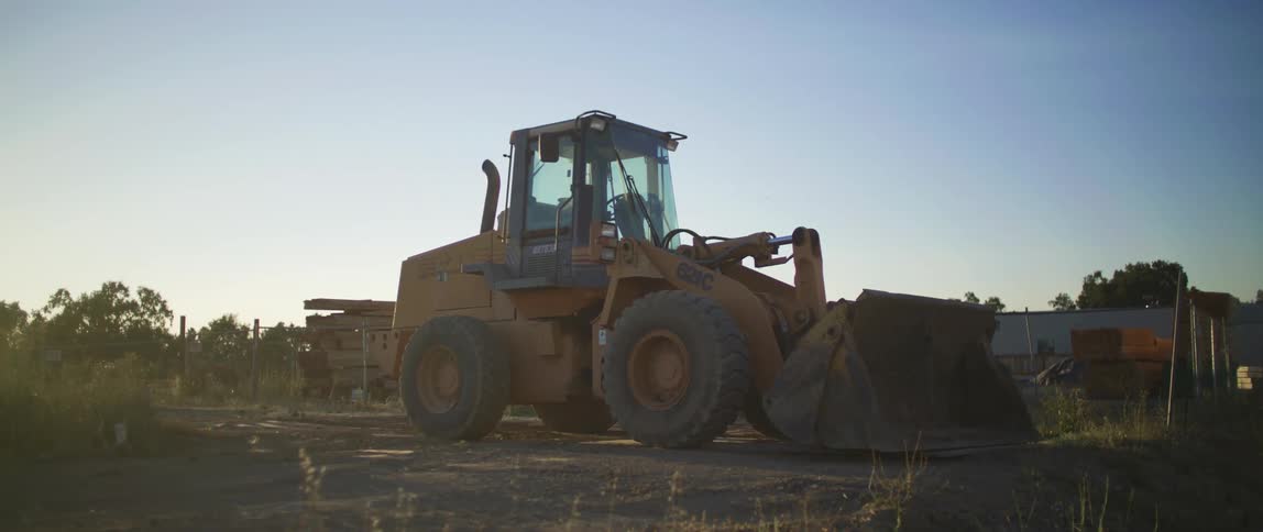 An excavator tractor is sitting at a construction site