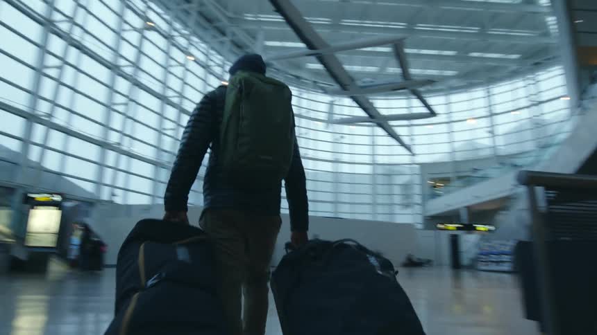 A man drags his bags through the airport