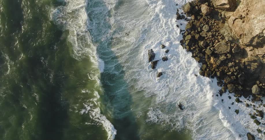 The view is of the ocean waves and cliff around the nature area
