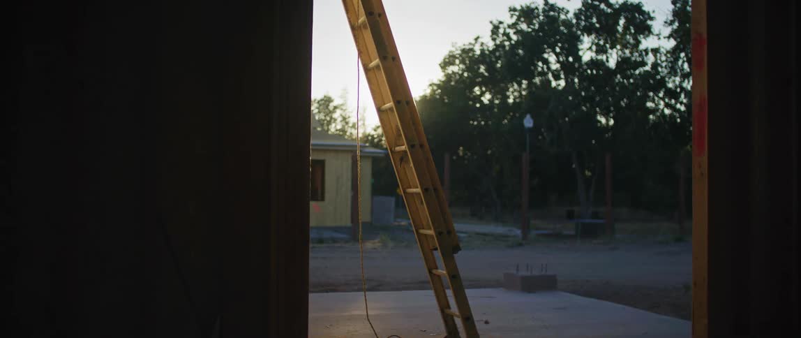A ladder leaned against the wall of an under construction home