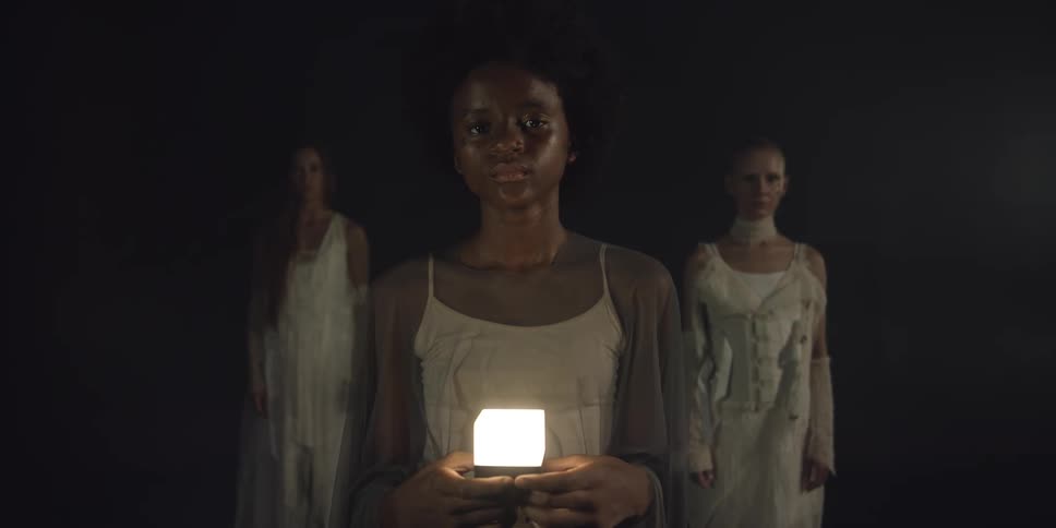 There are three young women standing next to each other