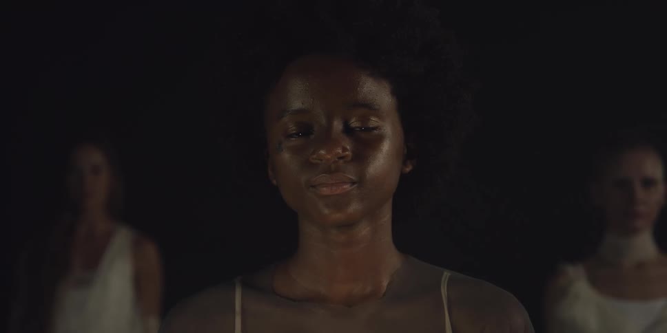 A woman is smiling in the dark