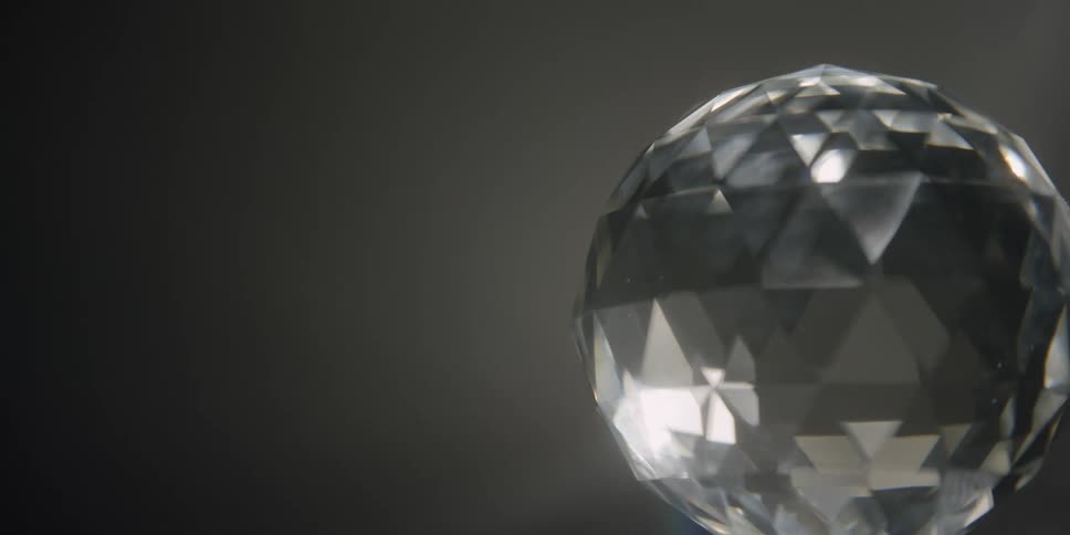 A crystal sphere with lights shining on it