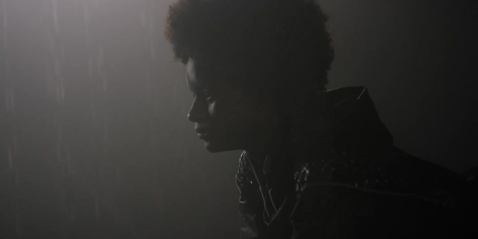 A young woman cries while standing in the rain
