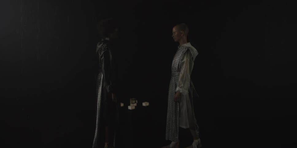 Two young women walking towards each other