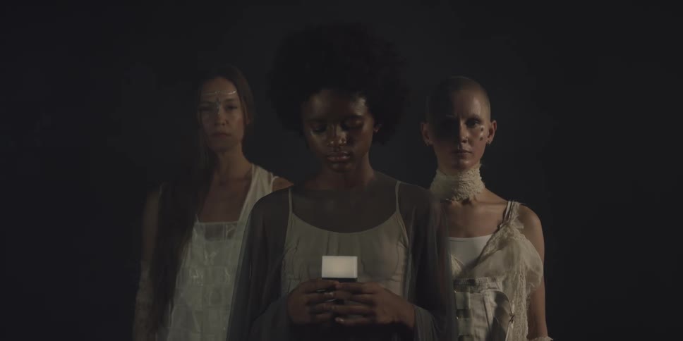 A woman is holding a glowing cube