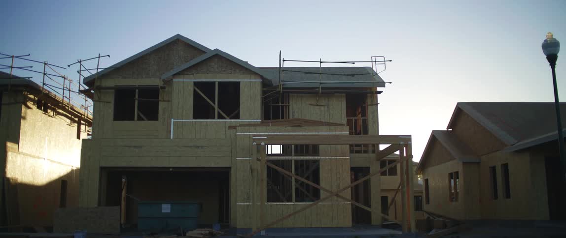 There is multiple houses that are located outside in the summer time