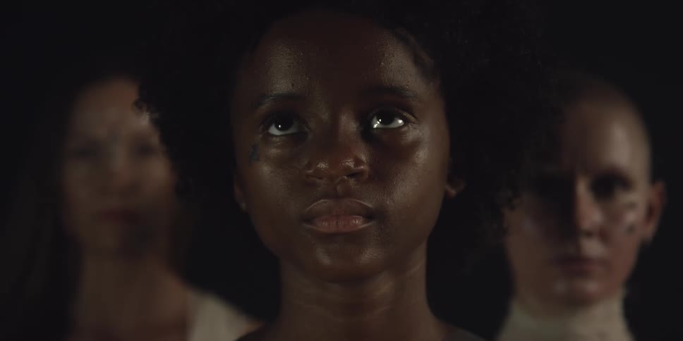 A woman tilts her head up