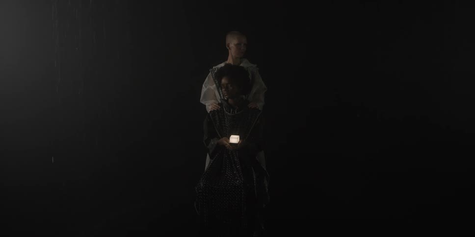 There are two woman that are standing by each other