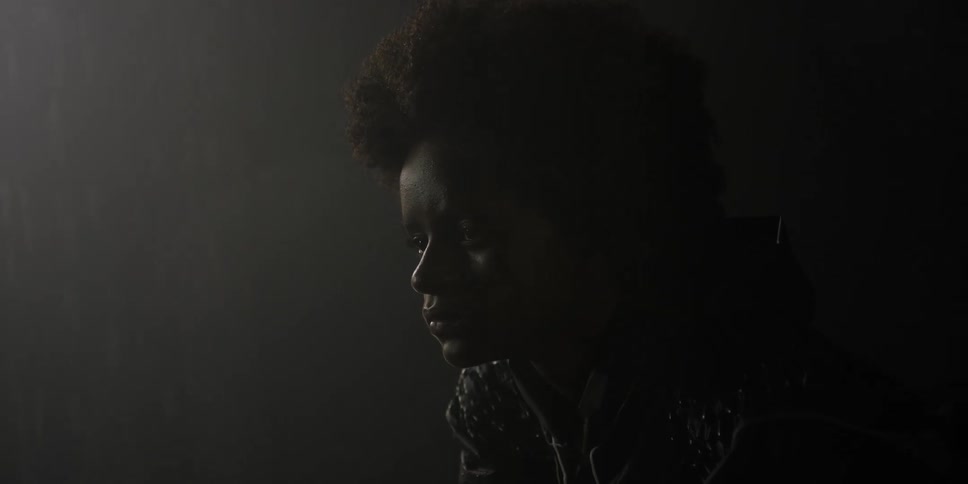 A woman is looking in the dark