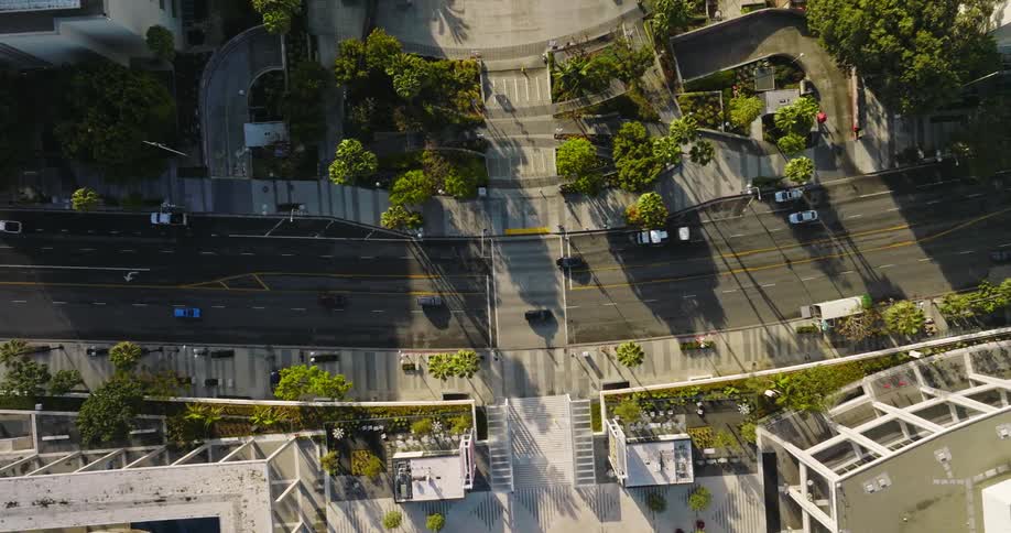 Steady traffic moves through a city neighborhood