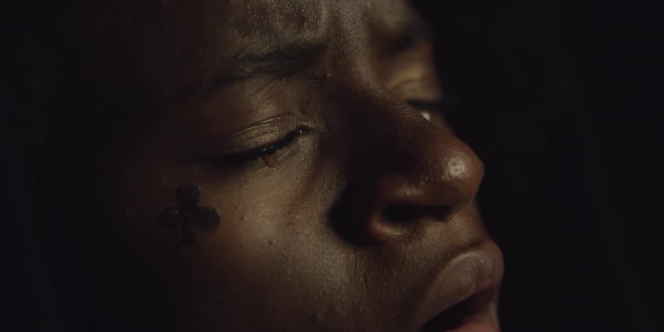A woman crying in a dark room