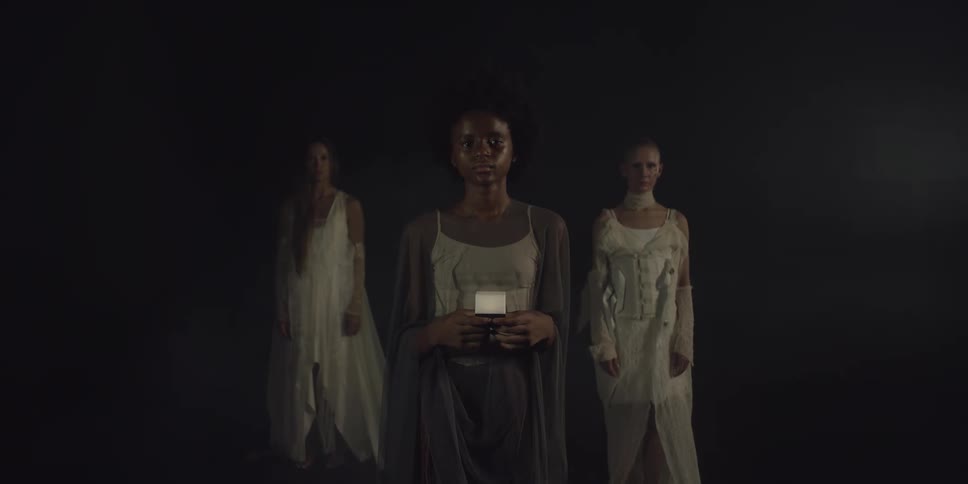 There are three young women standing next to each other