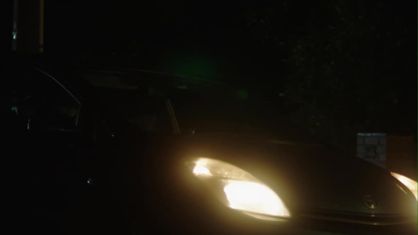 A man runs from one car and gets in another and drives away