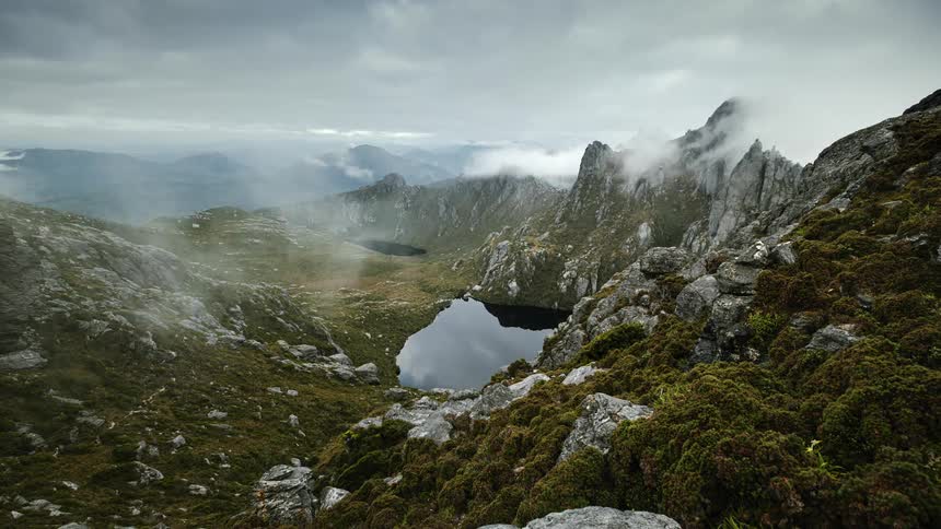 Cloud floating over a mountain lake in the wilderness