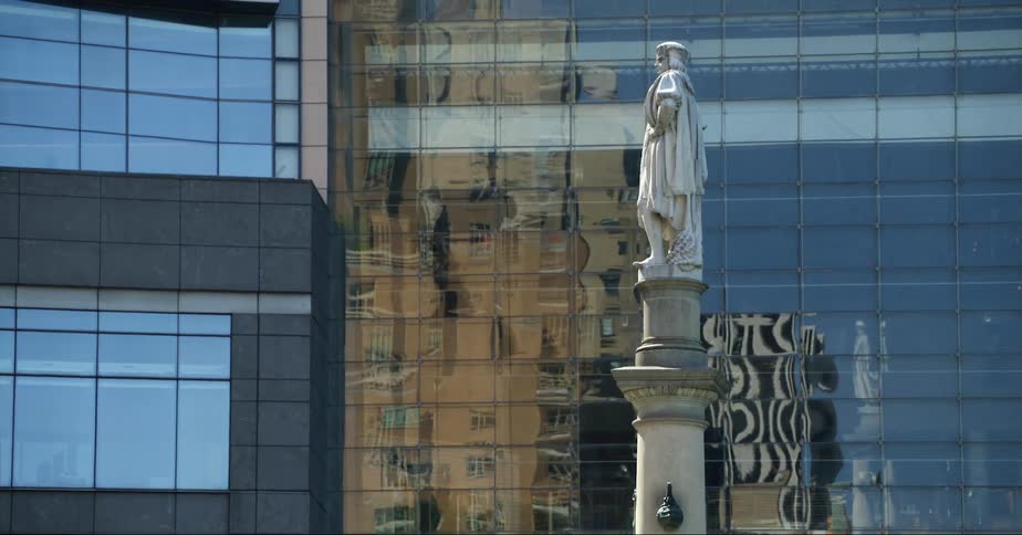 A view of a statue in the middle of a city