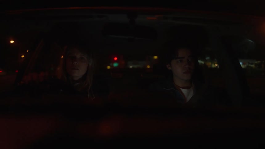 Man and woman are driving ina car together at night