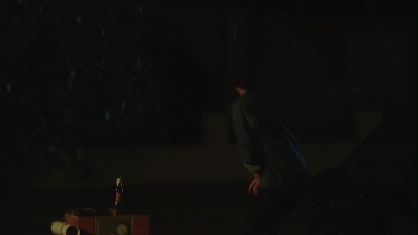A man outside takes a drink of a beer then bends down and clutches himself and calls for a car that drives up and he gets in