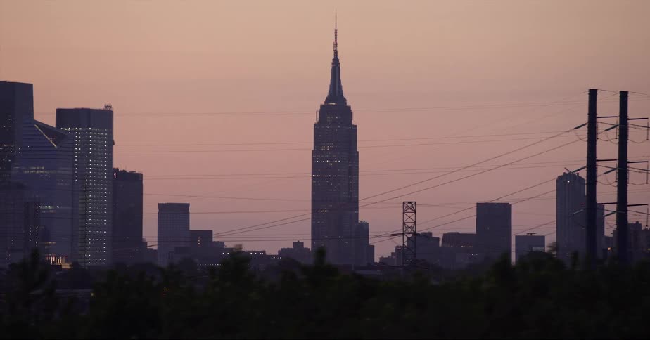 Distant view of skyscraper against the red sky at dawn in the city