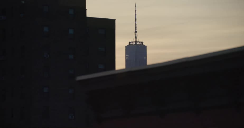 Top of the one world trade center in new york city between skyscrapers at evening