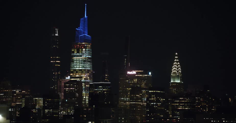 Downtown skyscrapers are lit up at night