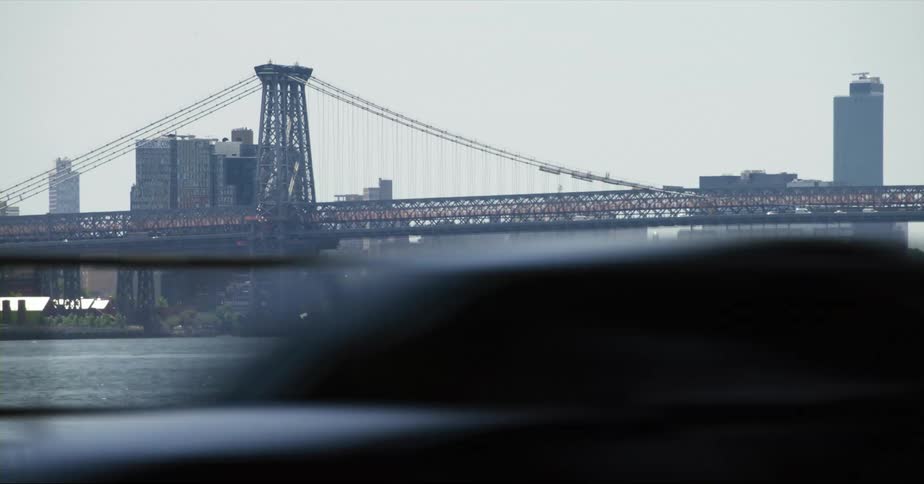 The williamsburg bridge in new york city seen from a moving vehicle at daytime