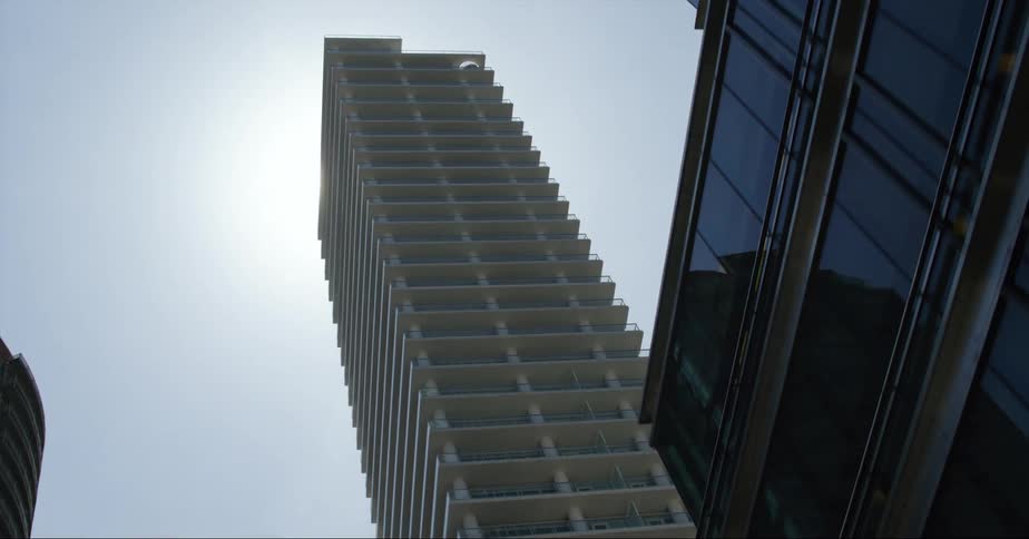 A tall apartment building looms over other skyscrapers