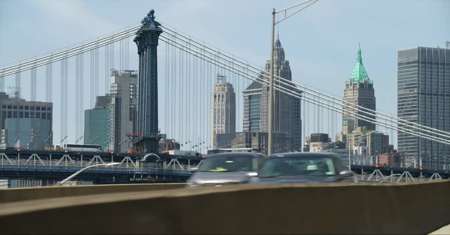 Cars are traveling on a freeway in new york near the manhattan bridge