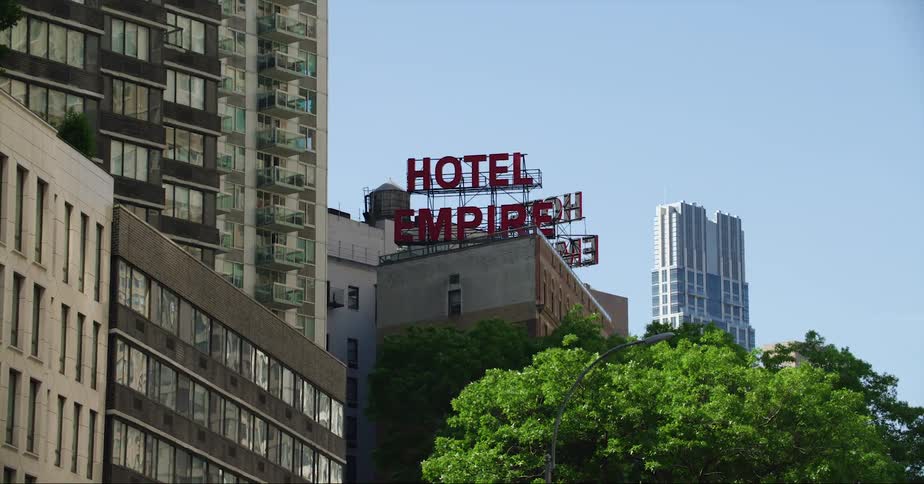 A large hotel sign is on top of the building