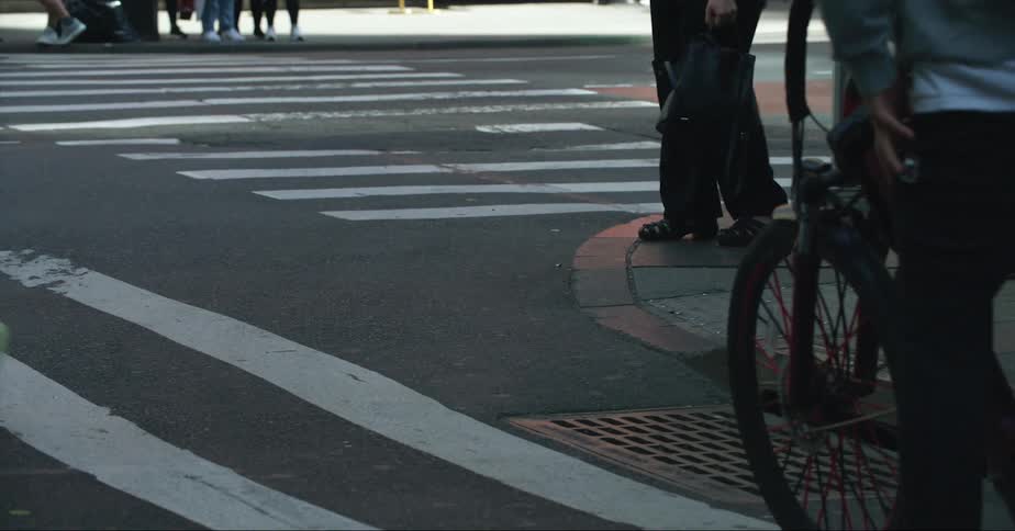 Pedestrians cross roads using crosswalks in the city