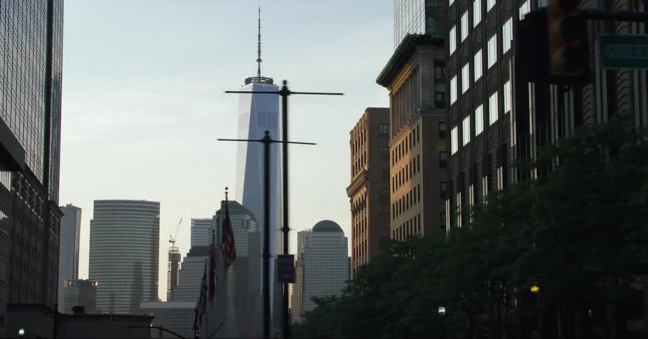 Skyscraper towering over nearby skyscrapers is visible between blocks at intersection